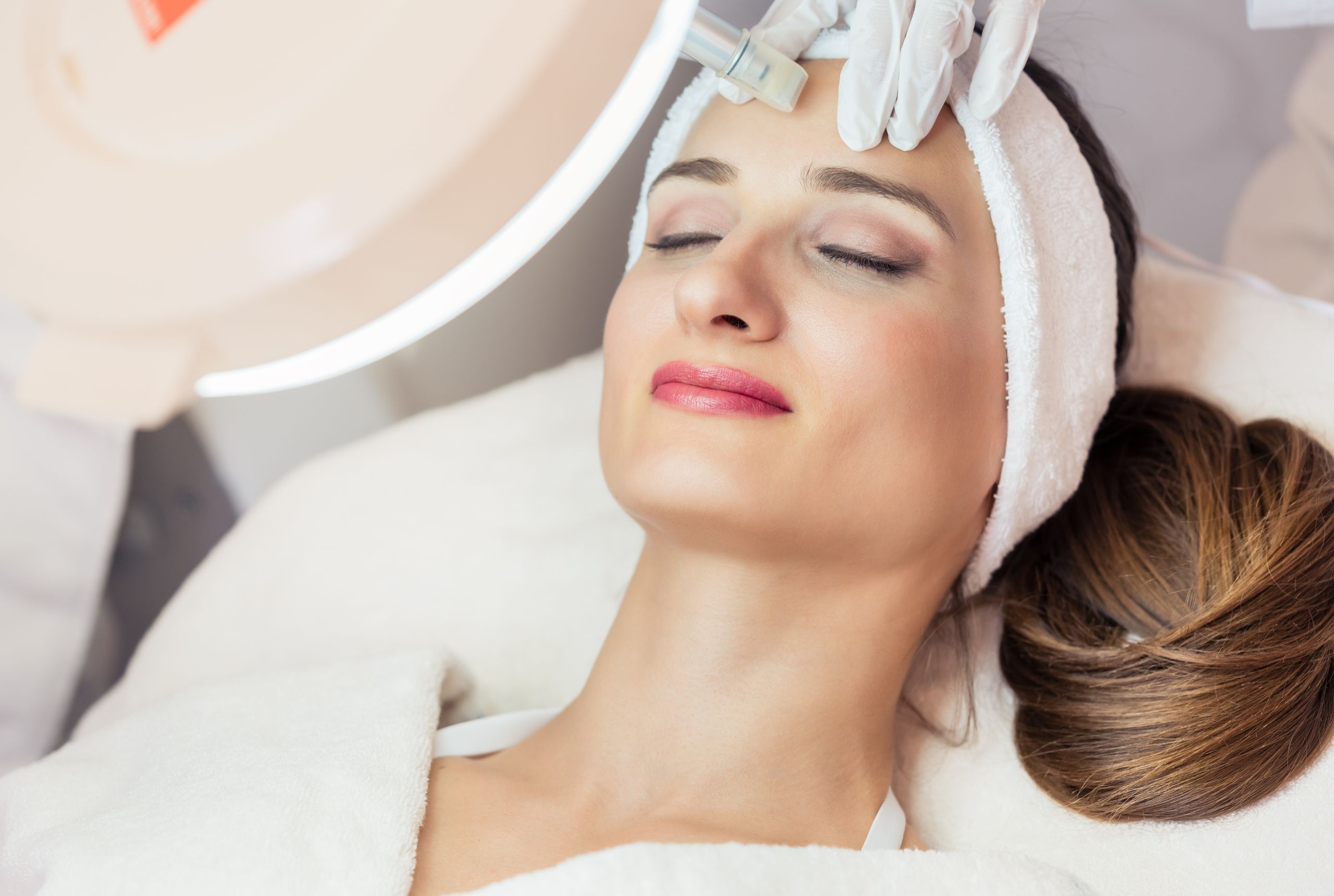 A young woman receiving an aesthetic facial treatment